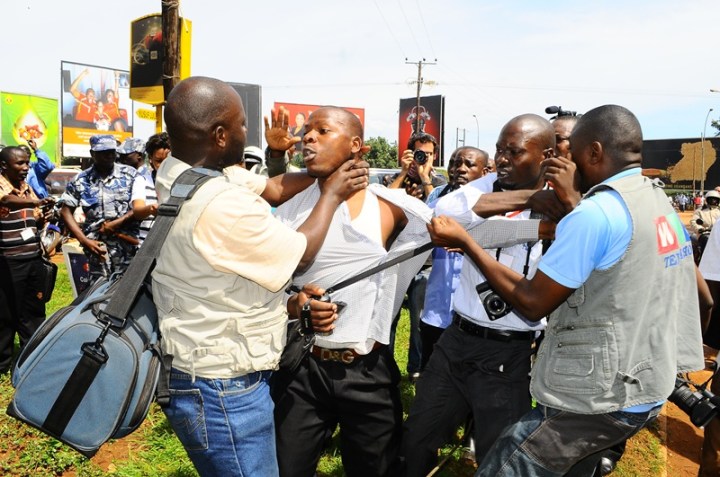 Journalists took the law into their hands and manhandled a man masquerading as a journalist. He was whisked away by plane clothed security men