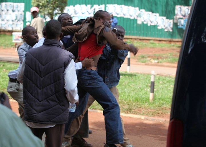 One of the men who did everything to protect Kizza Besigye is arrested after being sprayed with cans and cans of teargas/Pepper spray